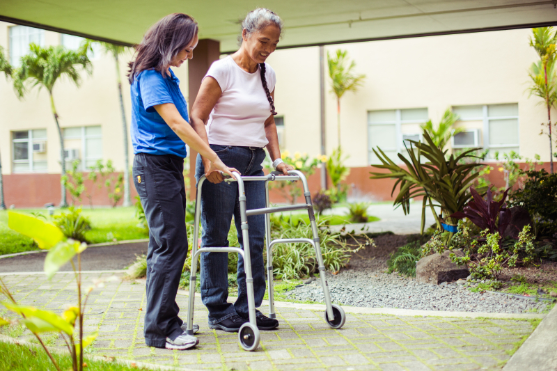 Rehab staff member talking with a rehabilitation patient