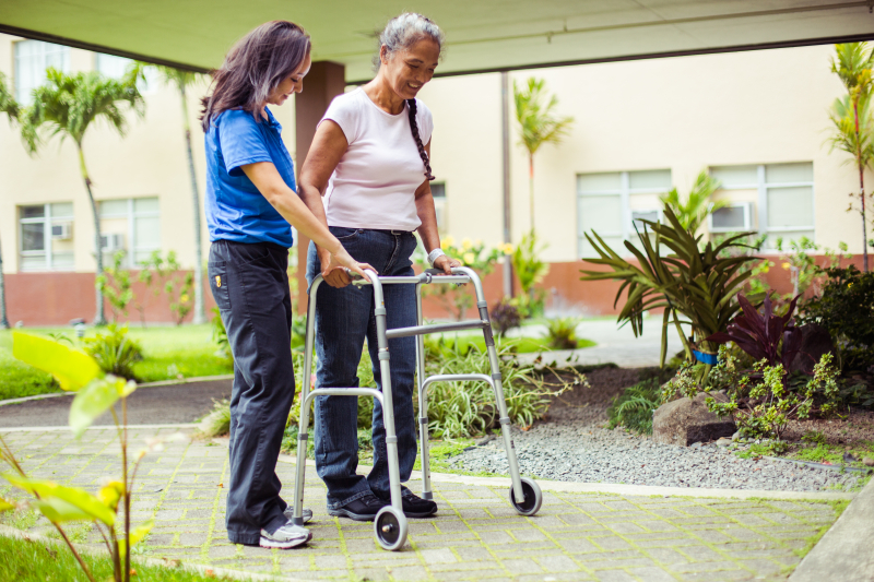 Rehab staff member talking with a rehabilitation patient