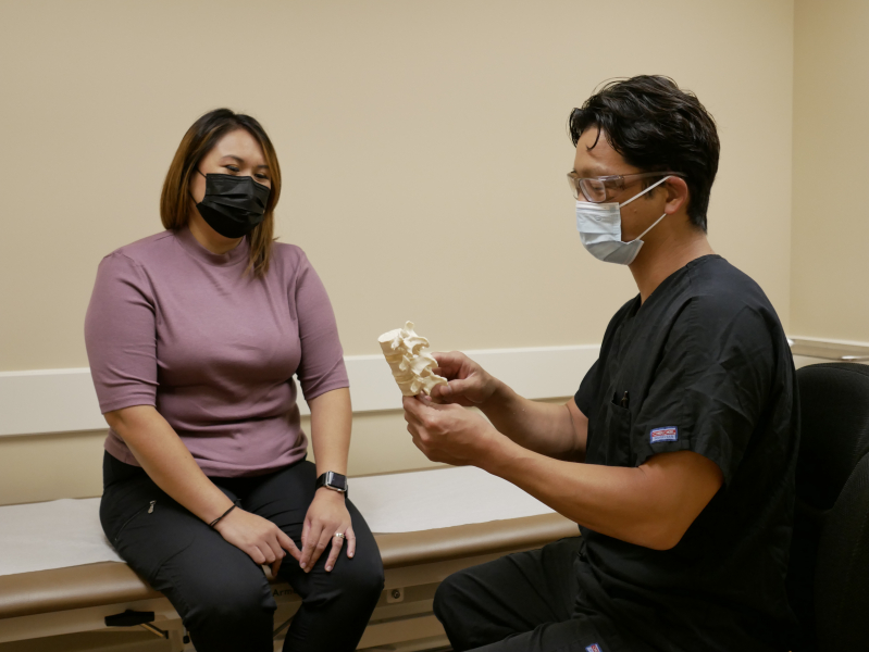 Rehab staff member talking with spinal cord rehabilitation patient