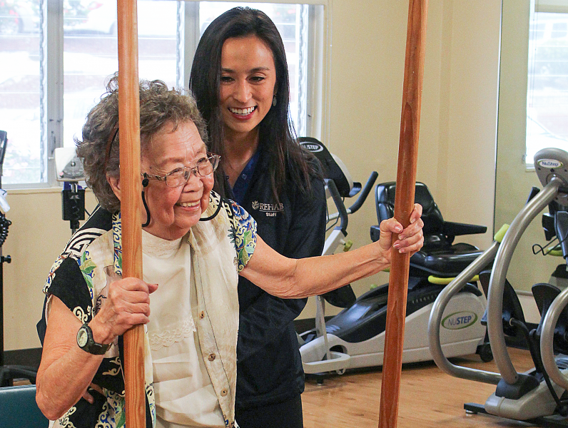 Urban garden with group standing around it patient receiving physical therapy