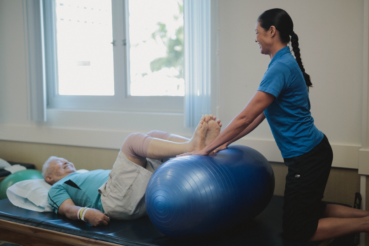 Rehab staff member assisting patient with orthopedic rehabilitation