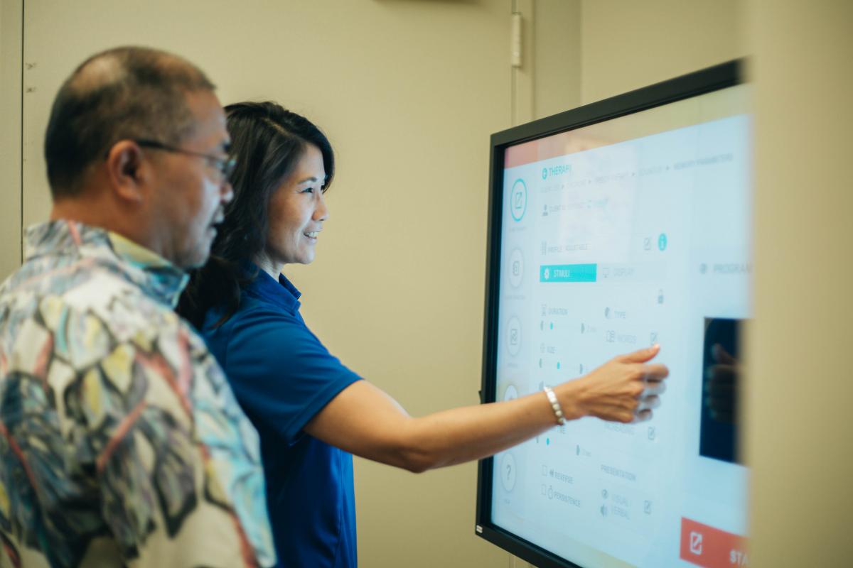 Rehab Hospital staff member working with patient using Bioness Integrated Therapy System