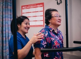 Therapist assisting a patient on the treadmill