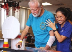 Patient being supported by a therapist to walk