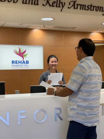 front desk representative talking to patient