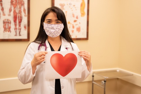 Dr. Shari Ann Oshiro holding a heart sign