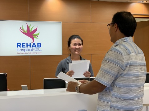 front desk representative talking to patient