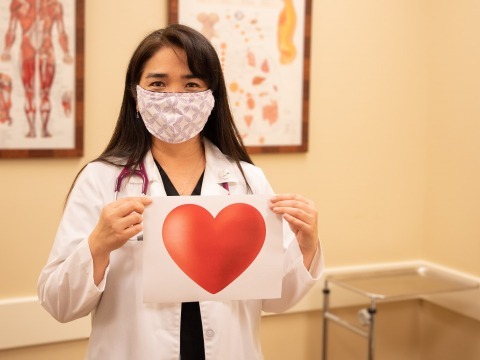 Dr. Shari Ann Oshiro holding a heart sign