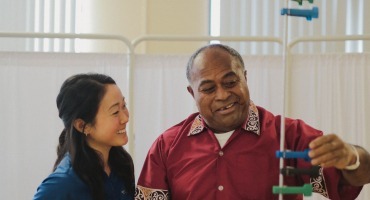 Stroke recovery patient in therapy with REHAB staff member